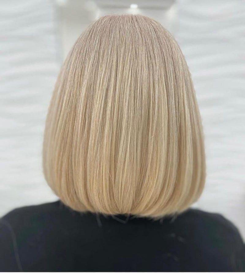 Sleek blunt blonde bob, seen from behind