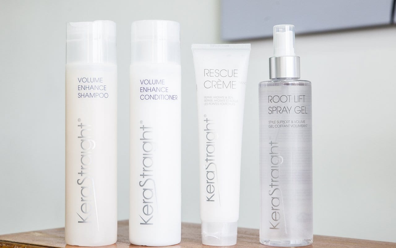 KeraStraight volume shampoo, volume conditioner, rescue crème and root lift spray gel on a wooden table